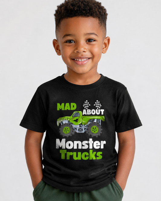 Boy models a black t-shirt with 'Mad About Monster Trucks' featuring bold text and tree truck and check flags - studio setting