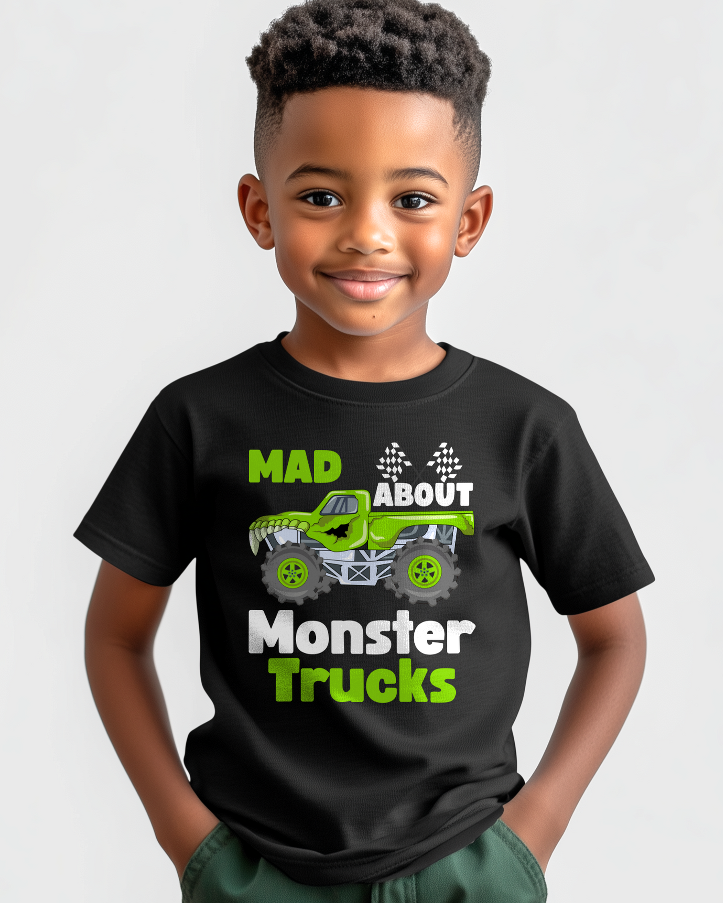 Child wearing a black t-shirt with 'Mad About Monster Trucks' graphic on a white background