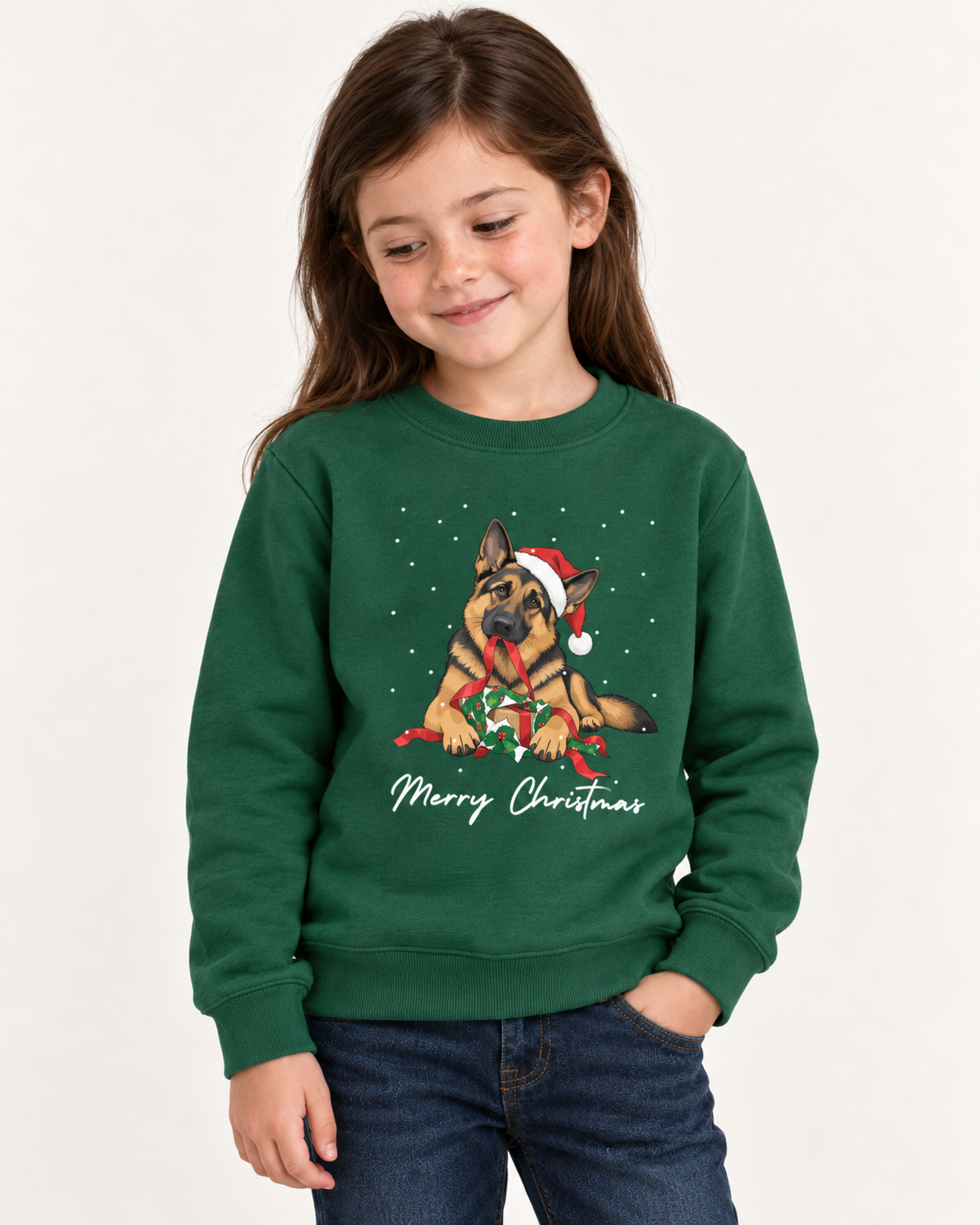 Girl wearing a dark green Christmas sweatshirt featuring a German Shepherd in a Santa hat holding a red ribbon beside an opened gift, with “Merry Christmas” lettering.