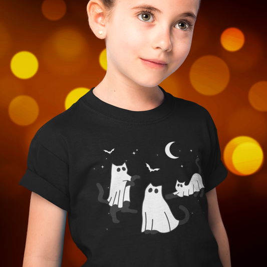 Girl wears black Halloween t-shirt with graphic printed Cats dressed in Ghost costumes with bats, moon and stars