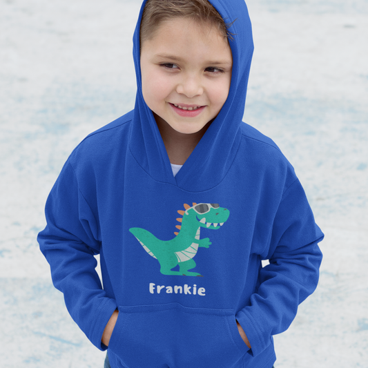 A cute dinosaur wearing sunglasses with a personalised name beneath on a boys hooded sweatshirt