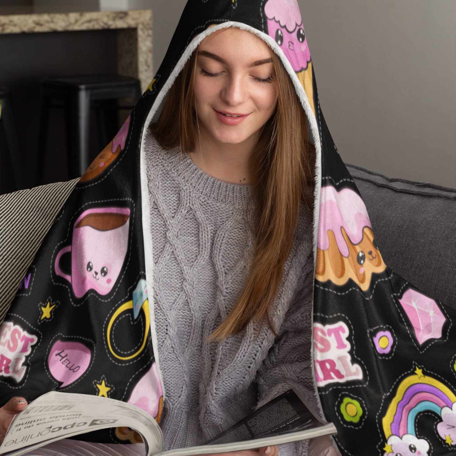 Girl wears premium hooded blanket sublimated printed with Kawaii characters, food, rainbows, cute faces, flowers on a black background