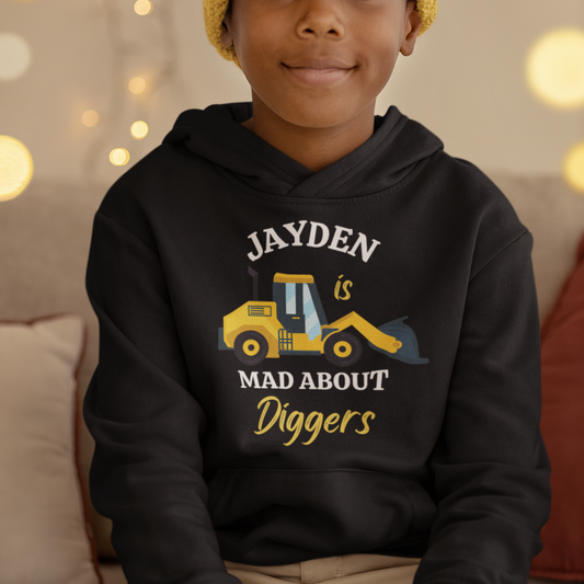 Boy wears black pullover hoodie with a yellow digger with the name at the top and 'Mad About Diggers' beneath