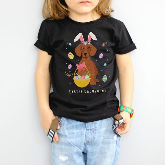 Kids Easter Dachshund T-shirt. Dachshund wearing Easter Bunny ears with decorative easter eggs, basket and flowers.